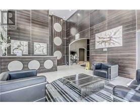 A modern office lobby with a reception desk and seating area.