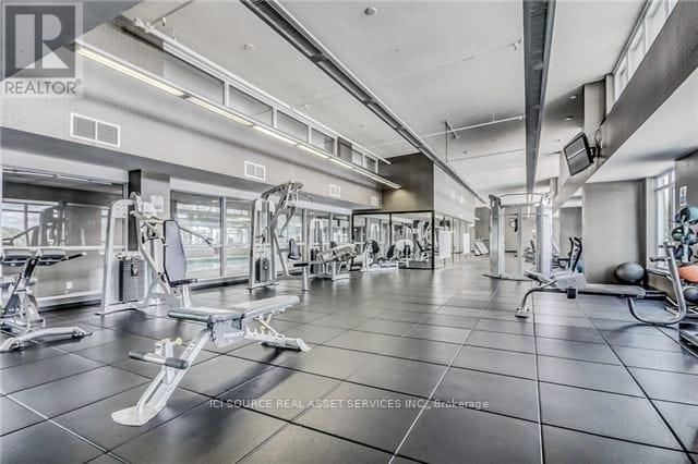 A gym with a variety of equipment including weights and machines.
