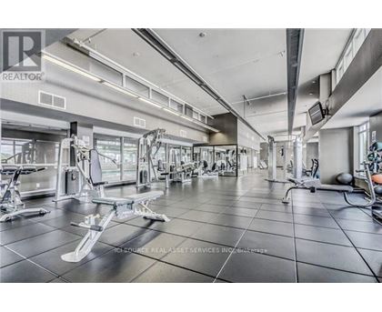 A gym with a variety of equipment including weights and machines.
