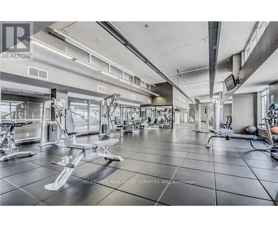 A gym with a variety of equipment including weights and machines.