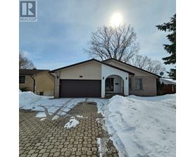 A house with a brown garage door and a driveway covered in snow.