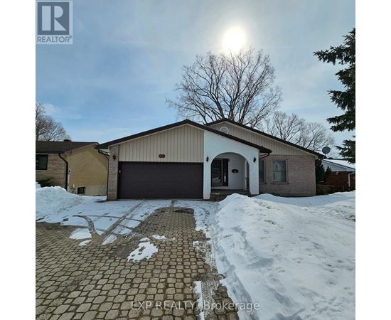 A house with a brown garage door and a driveway covered in snow.