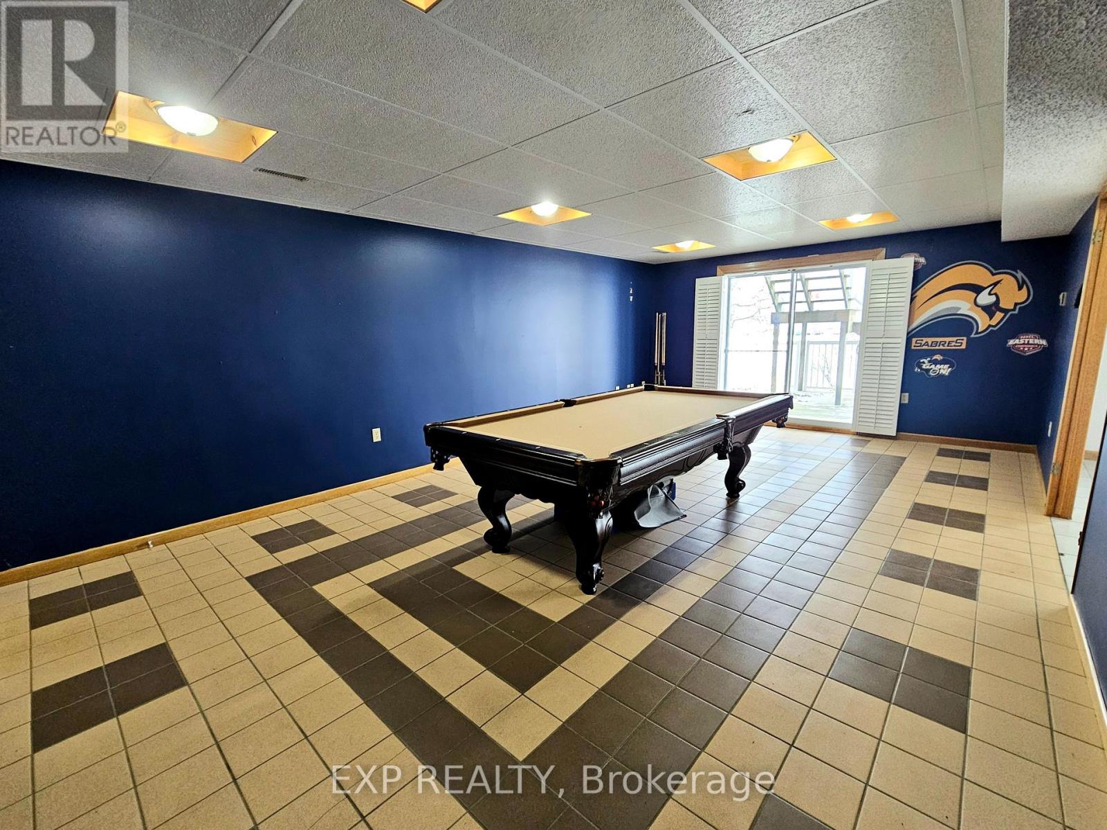 A pool table in a room with blue walls.