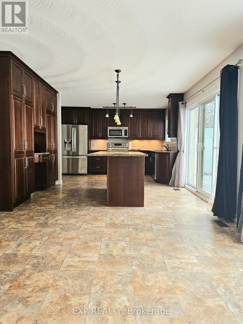 A kitchen with brown cabinets and a tiled floor.