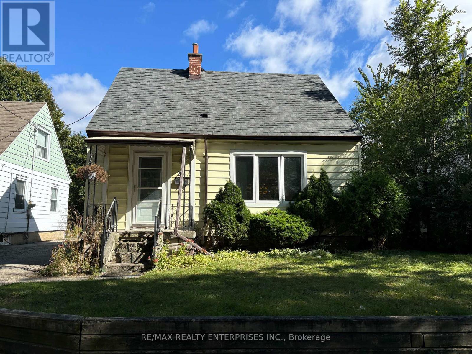A house with a small front yard is for sale.