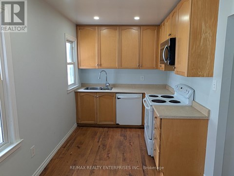 A kitchen with wooden cabinets and white appliances.