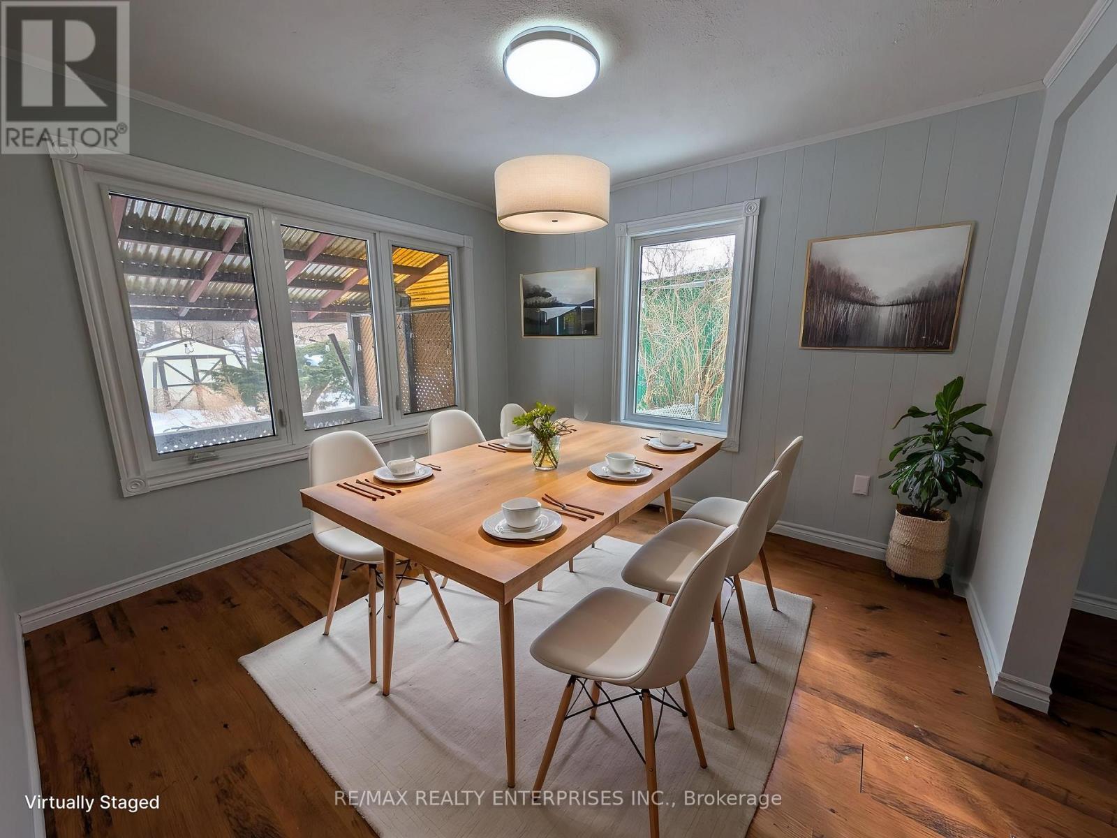 A room with wooden floors and a window on the right side.
