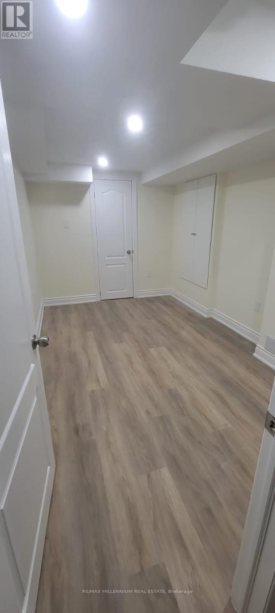 A room with wooden flooring and white walls.