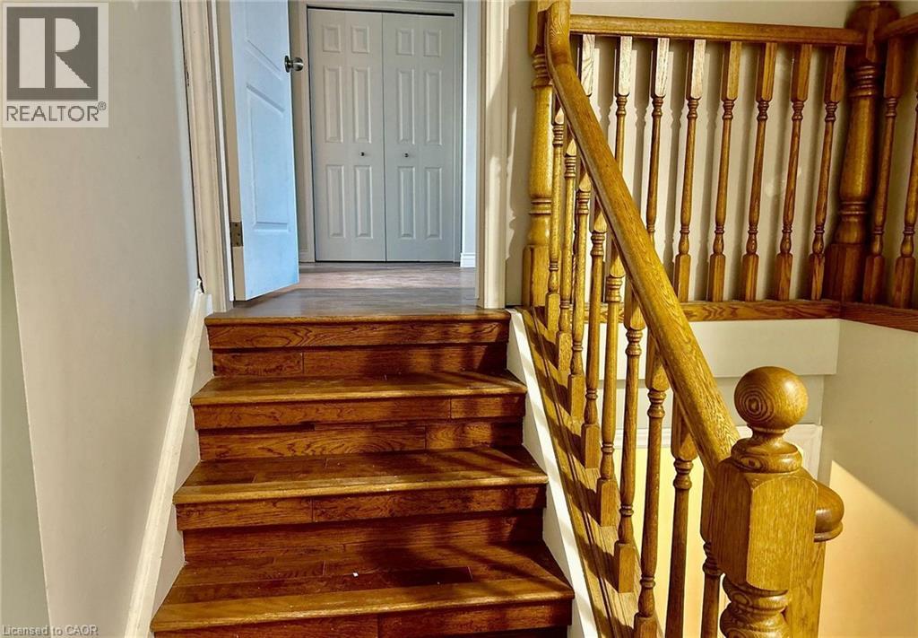 A wooden staircase with a white door in the background.