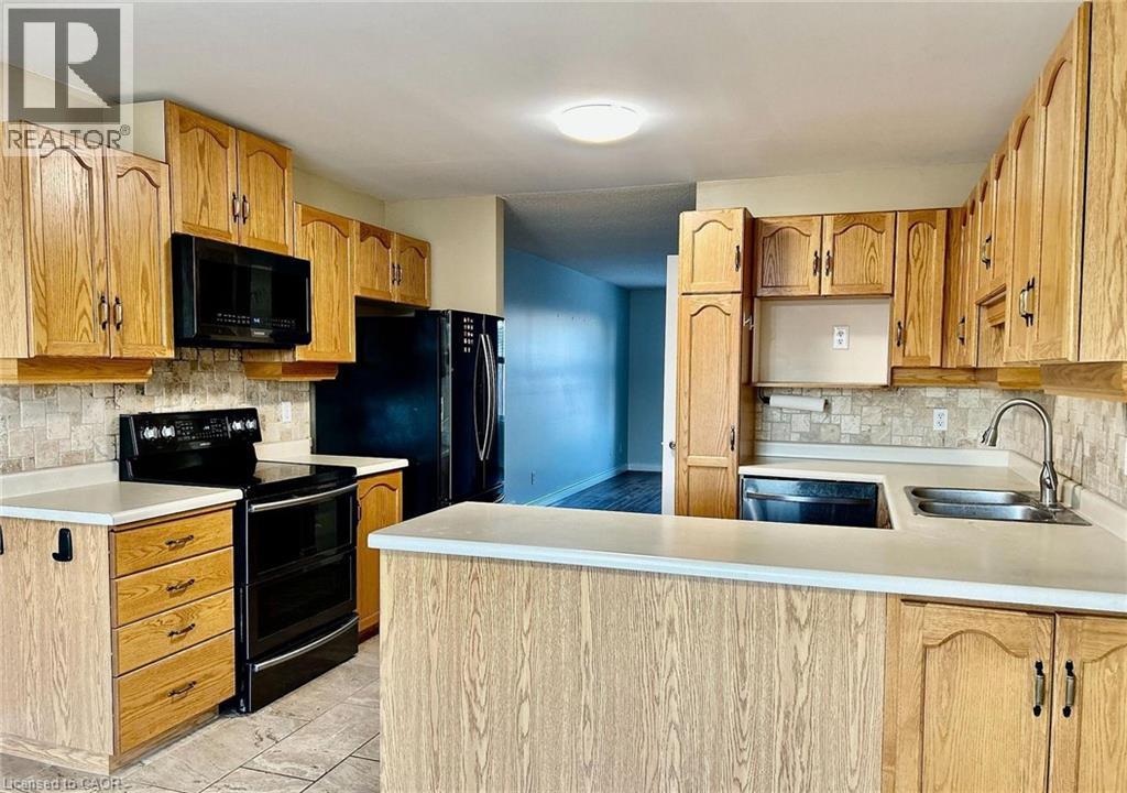 A kitchen with wooden cabinets and appliances.