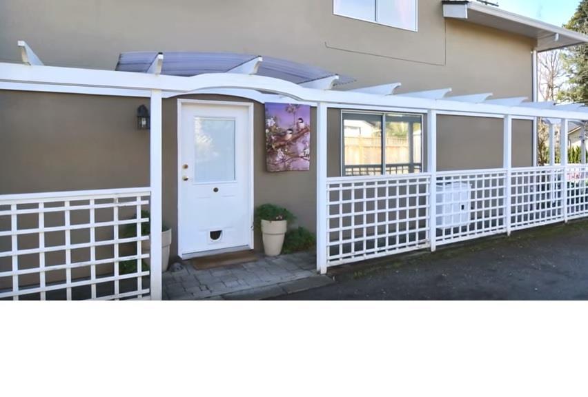 A house with a white fence and a white door.