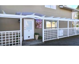A house with a white fence and a white door.