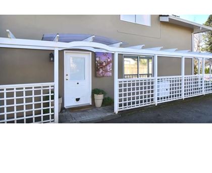 A house with a white fence and a white door.