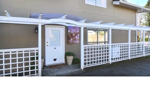 A house with a white fence and a white door.