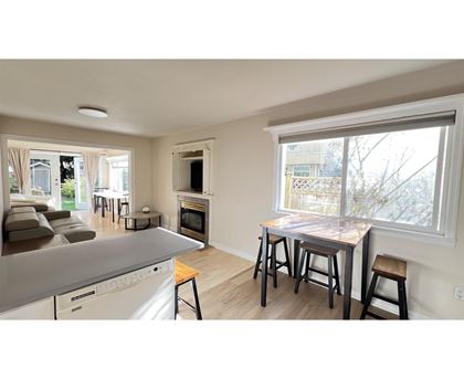 A kitchen with a dining table and chairs is shown.