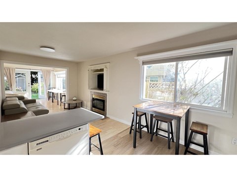 A kitchen with a dining table and chairs is shown.