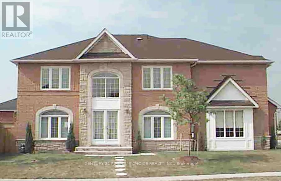 A brick house with a white door and windows.