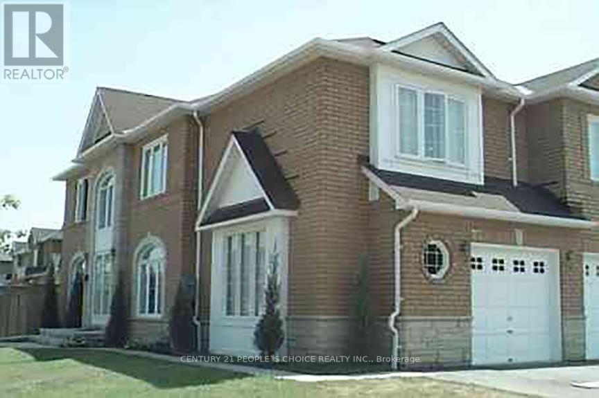 A house with a brown brick exterior and white trim.