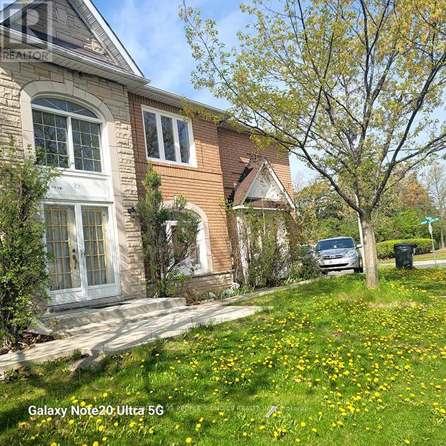 A Galaxy Note20 Ultra 5G phone is being used to take a photo of a house with a tree in front of it.