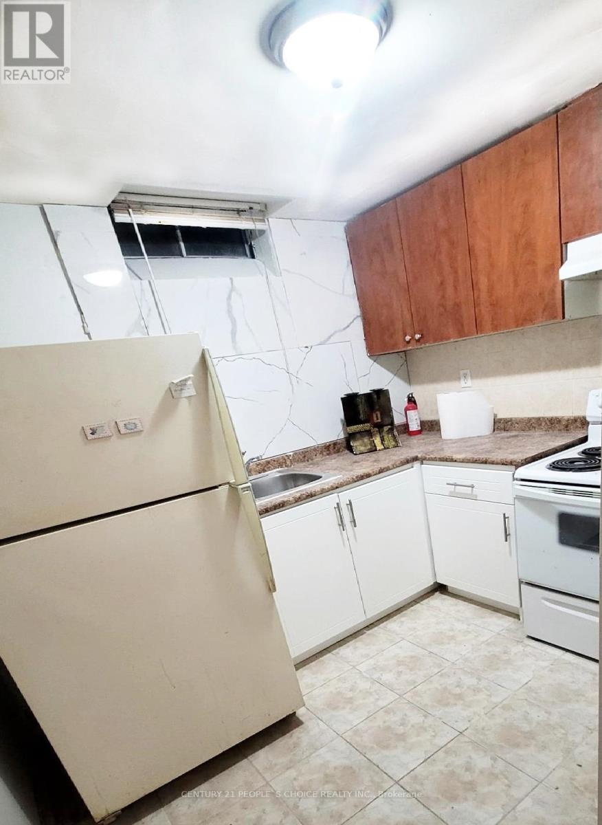A kitchen with a white fridge and white appliances.