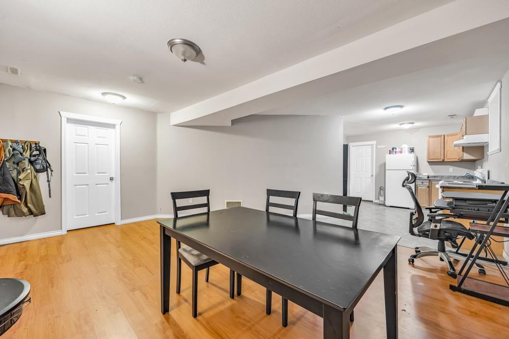 A dining room with a table and chairs.