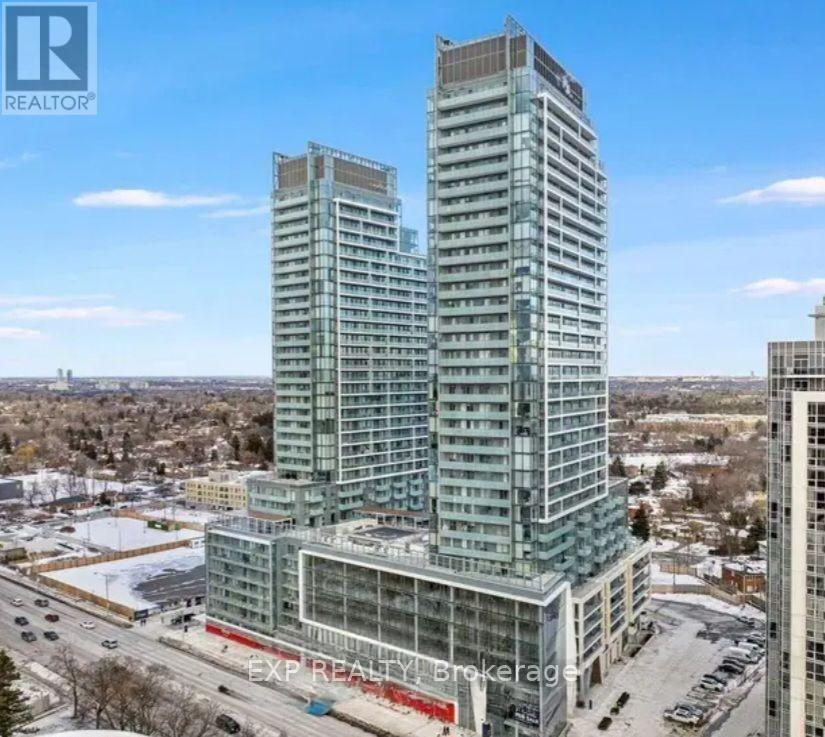 A tall building with a glass facade stands in the foreground of a snowy landscape.