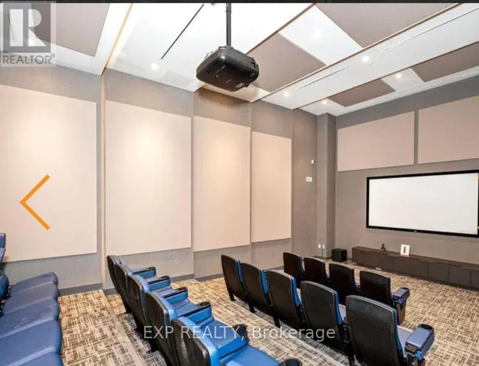 A conference room with a projector screen and chairs.