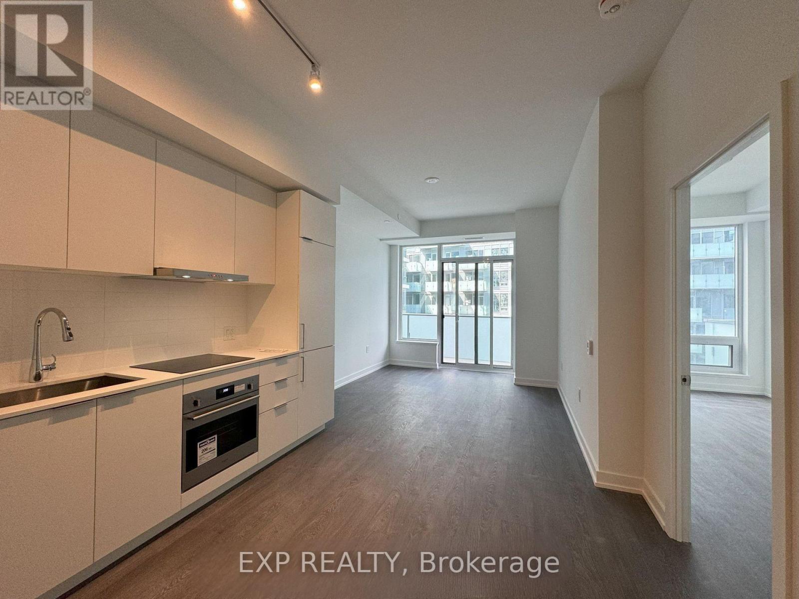 A kitchen with white cabinets and a stainless steel oven.