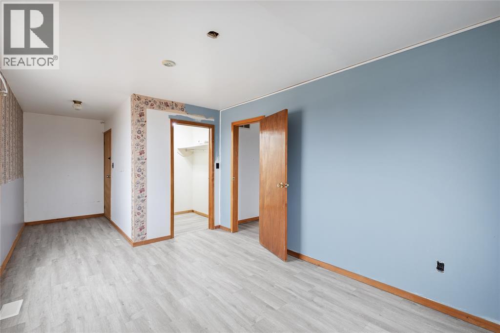 A room with a blue wall and a wooden door.
