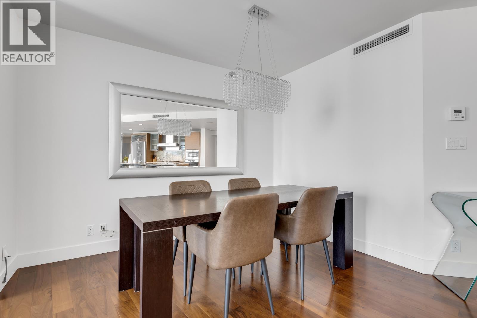 A dining room with a table and chairs.