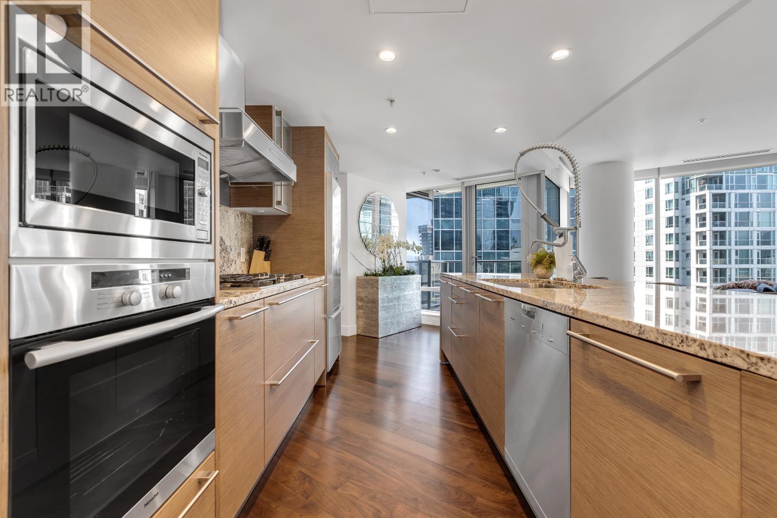 A modern kitchen with wooden cabinets and stainless steel appliances.