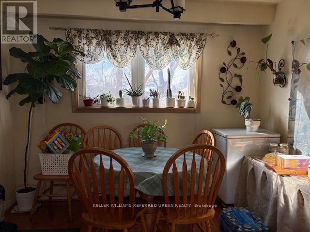 A dining room with a table and chairs.