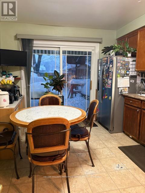 A kitchen with a table and chairs.