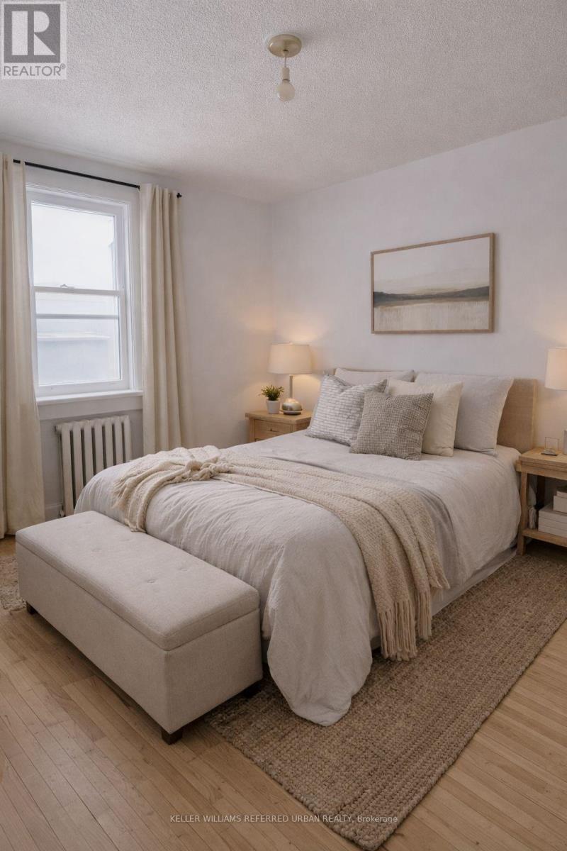 A bedroom with a large bed and a window.