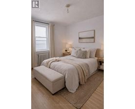 A bedroom with a large bed and a window.