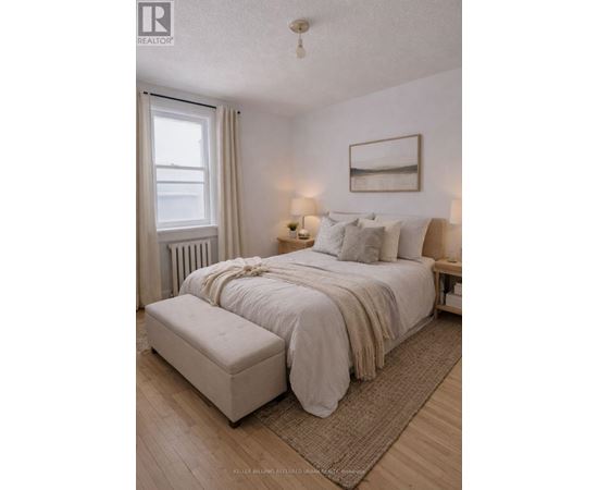 A bedroom with a large bed and a window.