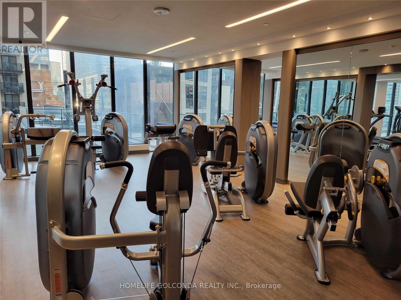 A gym with a row of exercise bikes.