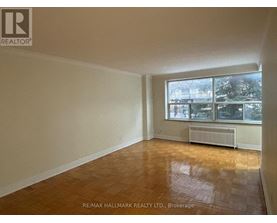 A room with a window and a radiator on the floor.