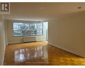 A room with a large window and a radiator on the wall.