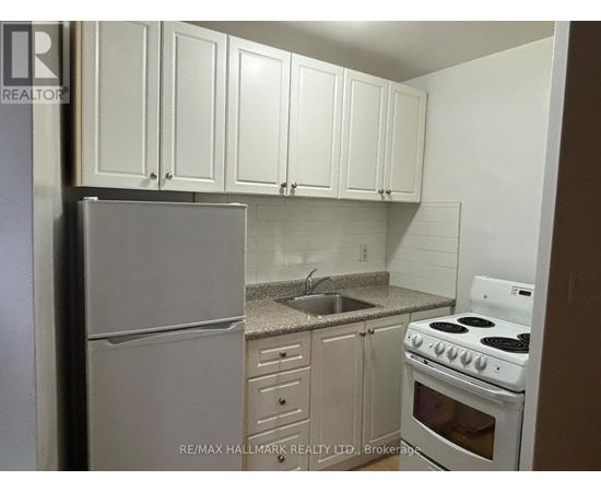 A kitchen with white cabinets and appliances.