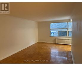 A room with a window and a radiator on the floor.
