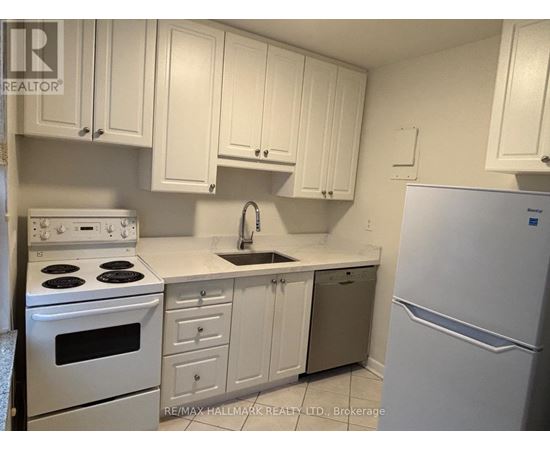 A kitchen with white cabinets and appliances.