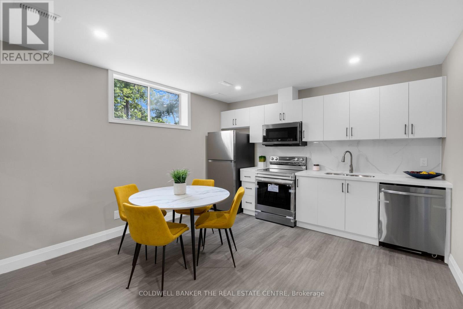 A modern kitchen with a dining table and chairs.