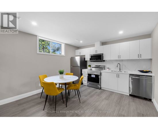 A modern kitchen with a dining table and chairs.