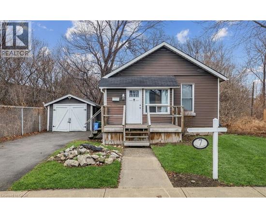 A house with a garage and a small shed is for sale.