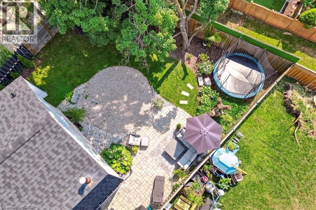 A backyard with a hot tub and patio furniture.