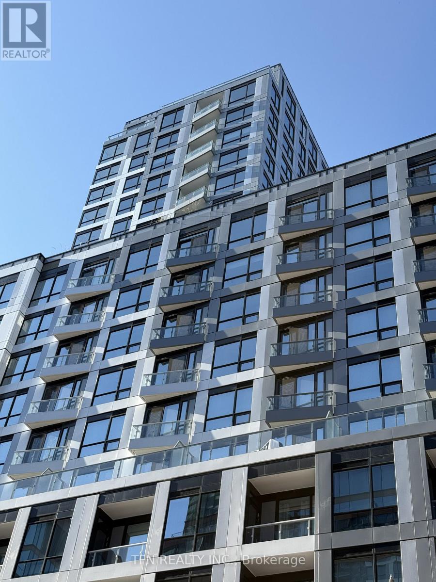 A tall building with many windows and balconies is shown.