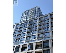 A tall building with many windows and balconies is shown.