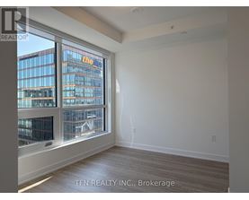 A room with a large window overlooking a cityscape.
