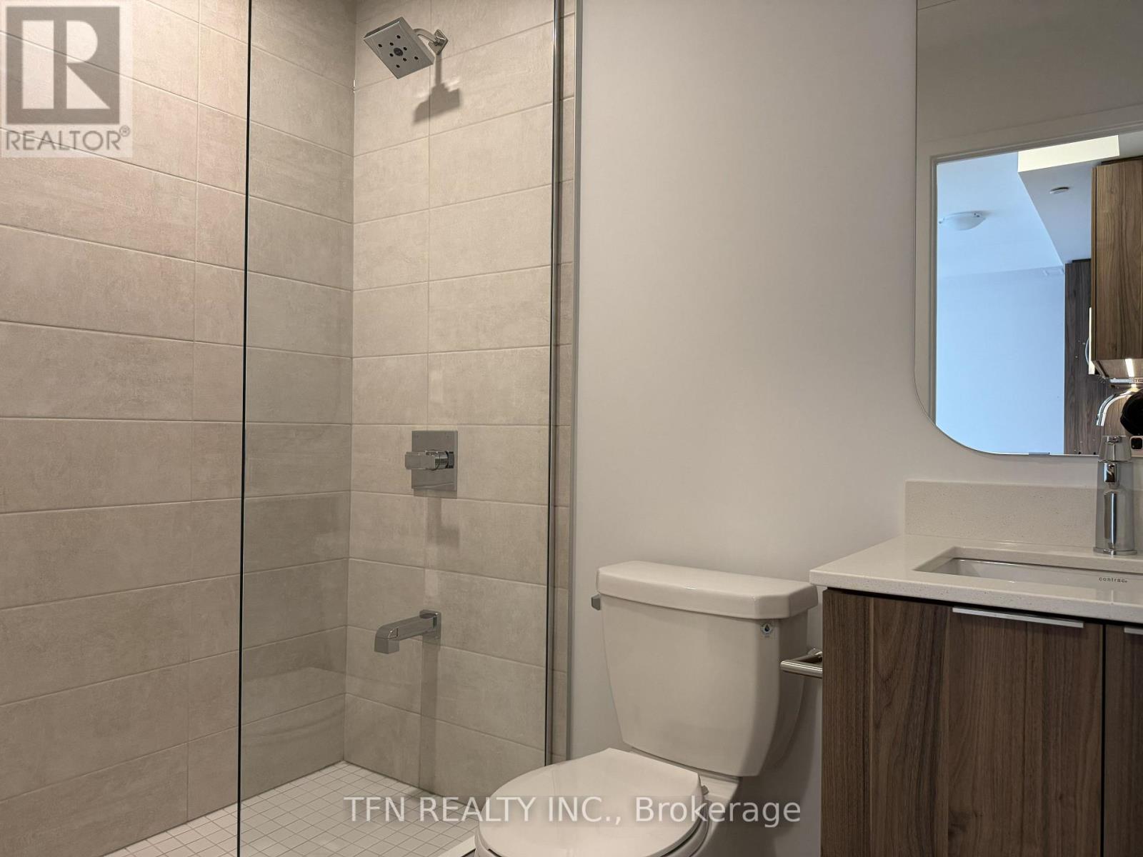 A bathroom with a walk-in shower and a toilet.